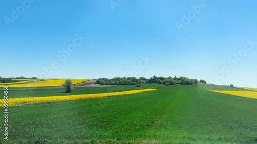 View from the train window on agricultural fields in Poland in spring.