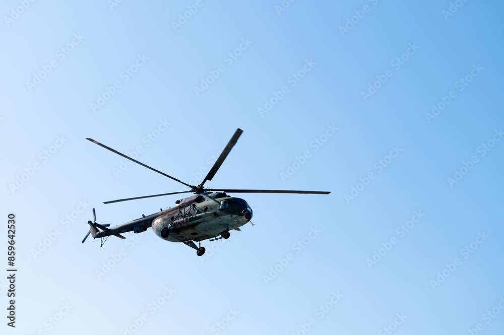Military large aircraft flies over a clear blue sky, close-up Military large aircraft flies over a clear blue sky, close-up