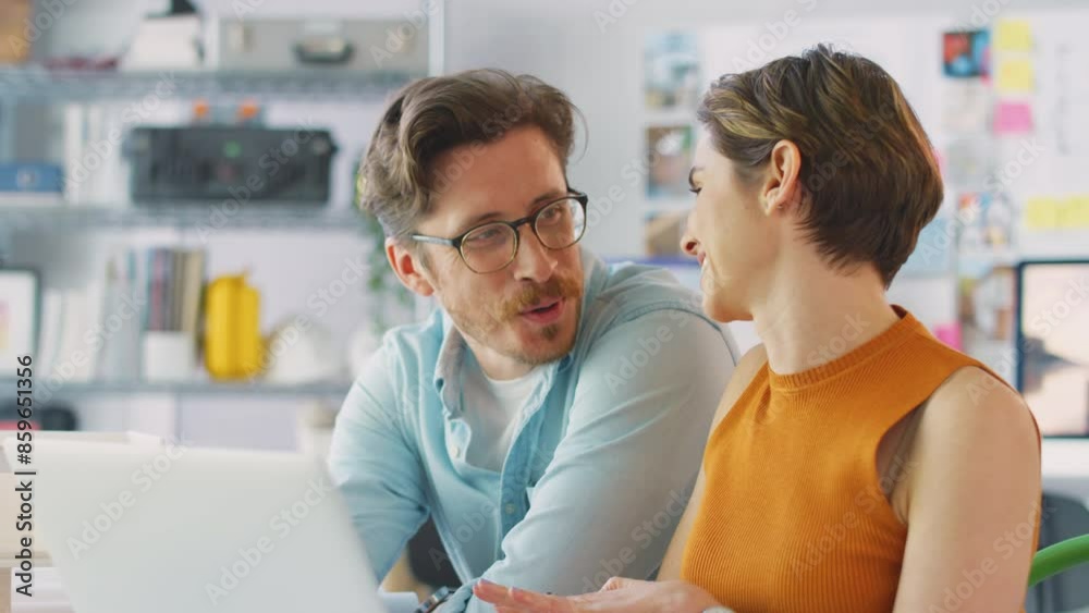 Camera tracks across frame as casually dressed female architect working at desk in office talking on mobile phone - shot in slow motion Camera tracks across frame as casually dressed female architect working at desk in office talking on mobile phone - shot in slow motion