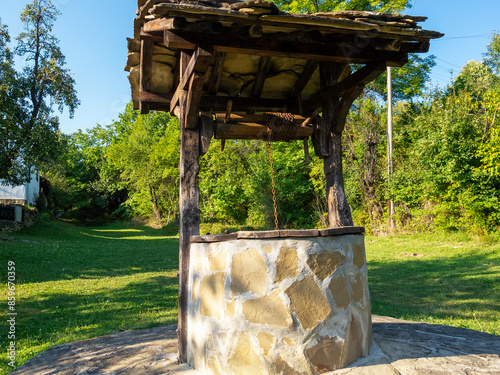 Traditional Bulgarian old water well at Baba Stana Neighborhood, Oreshak, Troyan Municipality, Lovech Province, Bulgaria photo