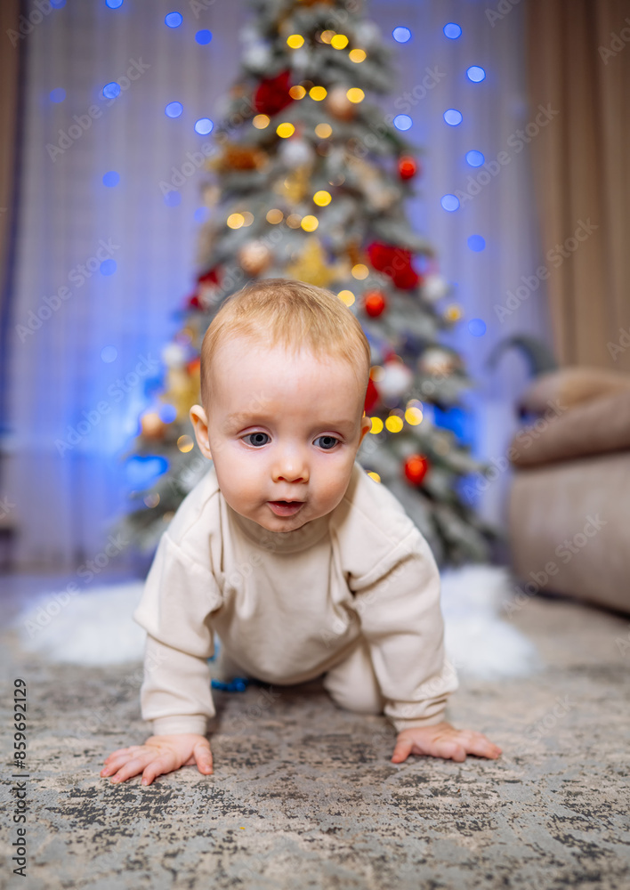 Baby Crawling Near Christmas Tree. A baby crawls on a carpet in front of a Christmas tree. Baby Crawling Near Christmas Tree. A baby crawls on a carpet in front of a Christmas tree.
