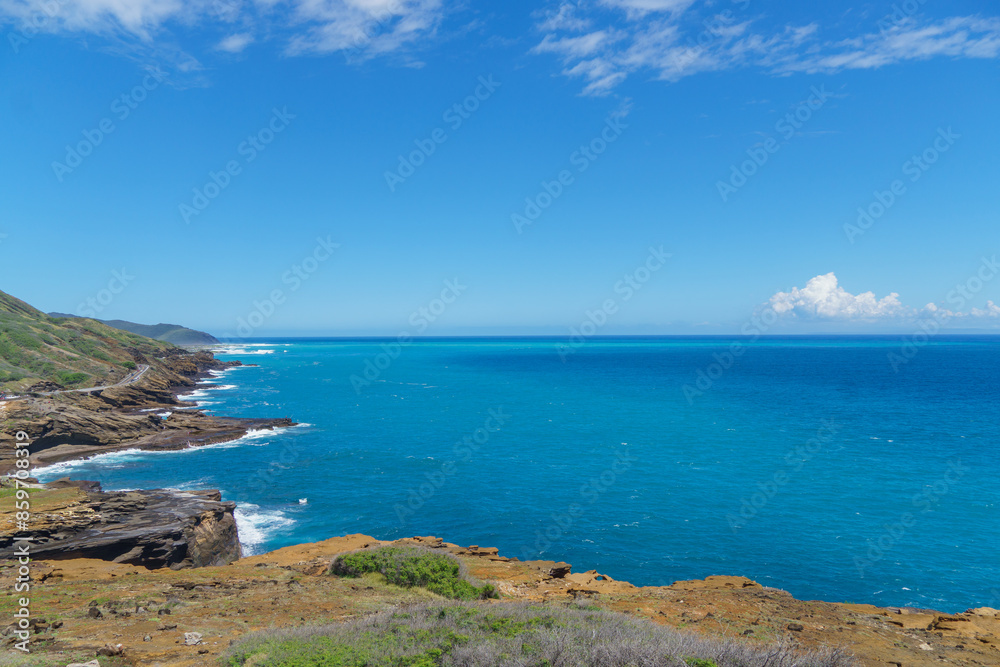 A breathtaking view of the ocean from a cliff on a beautiful sunny day A breathtaking view of the ocean from a cliff on a beautiful sunny day