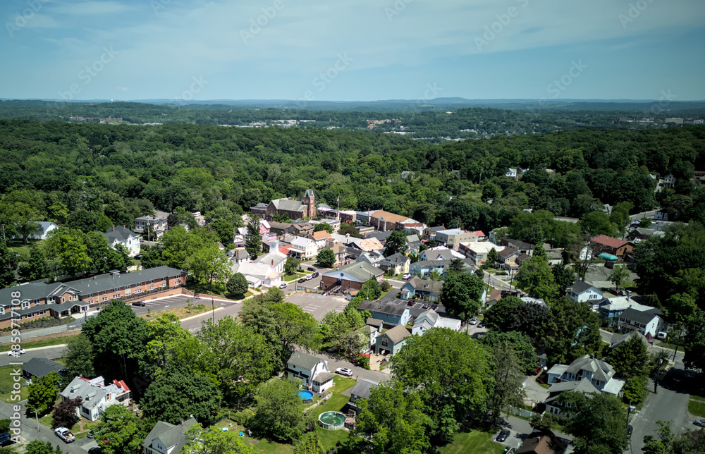 Obraz premium aerial view of the town of highland new york hudson valley next to poughkeepsie ulster county (church downtown historic commercial district with homes and distant mountains)
