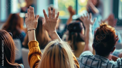 People raising their hands in a classroom or conference, eager to answer or ask a question. AIG535
