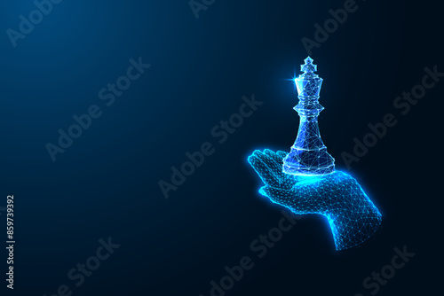 Leadership, strategic thinking futuristic concept with hand holding king chess piece on dark blue 