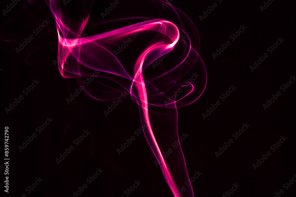 Obraz premium Abstract pink smoke on a black background, creating a fluid and dynamic pattern.