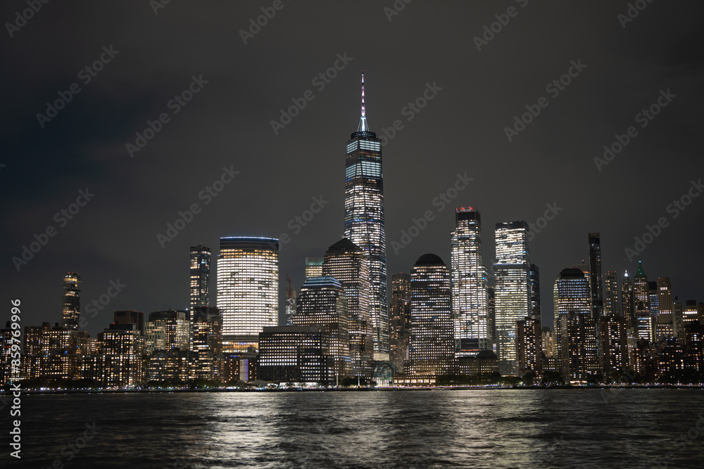Obraz premium Night in The NYC city, USA, United States. Night day with iconic buildings. New York City NYC Manhattan Downtown Skyline, viewed from Jersey City, USA.