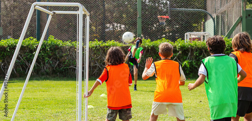 Foto Youth Soccer Match with Colorful Training Bibs