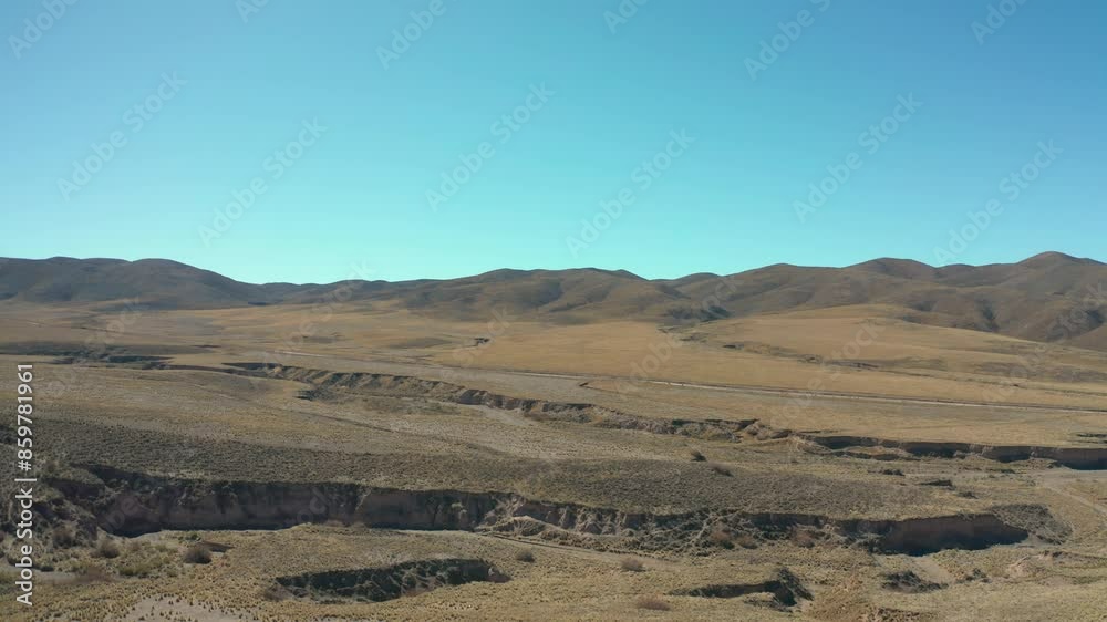 Snow-Covered Mountain Range with dry Winding River Snow-Covered Mountain Range with dry Winding River