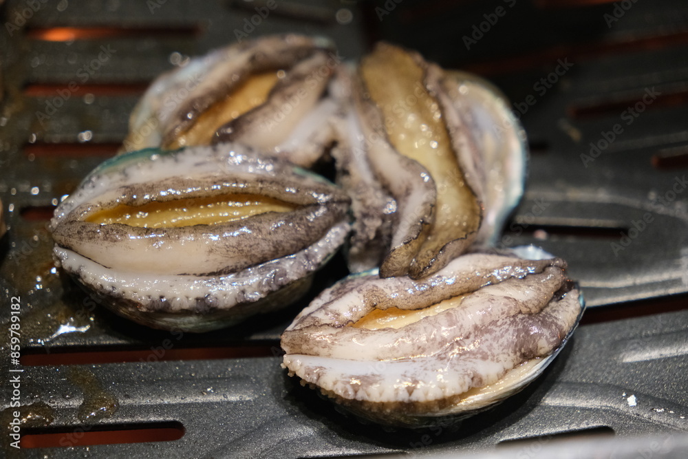 close up cooking abalone seafood on barbecue grill close up cooking abalone seafood on barbecue grill