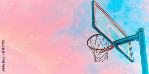 Aro de basquete com pôr do sol dramático ao fundo photo