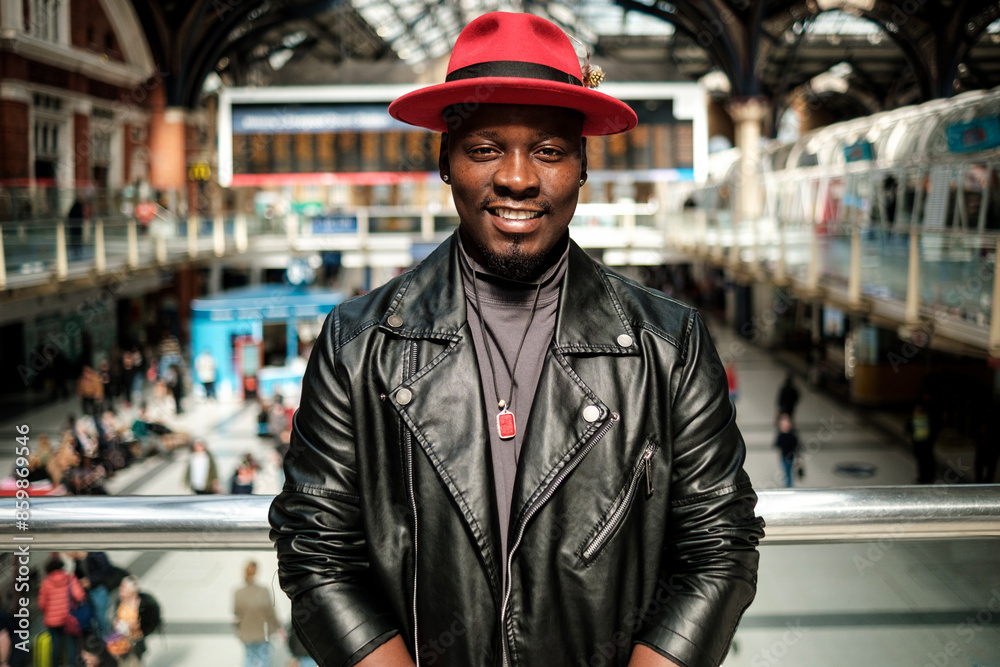 Smiling man looking at camera in a train station. Smiling man looking at camera in a train station.