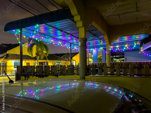 Abstract background colourful neon glowing lights outside the house with reflection.
