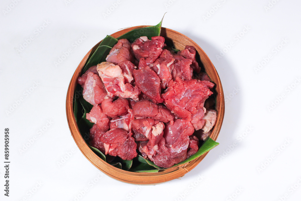 The beef is cut into cubes and served on a bamboo basket lined with banana leaves The beef is cut into cubes and served on a bamboo basket lined with banana leaves