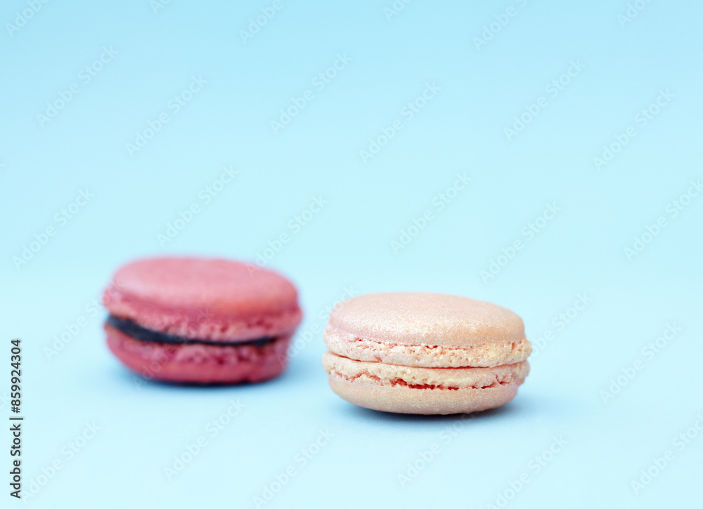 Baked dessert, candy and display of french sweets with variety, delicacy and treats on blue background. Cookies, macaroons and different flavors of confectionery for bakery, fine dining and luxury Baked dessert, candy and display of french sweets with variety, delicacy and treats on blue background. Cookies, macaroons and different flavors of confectionery for bakery, fine dining and luxury
