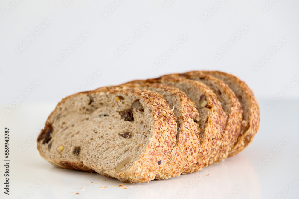5 slices of whole grain brown raisin and walnut bread against white background, healthy eating and lifestyle concept 5 slices of whole grain brown raisin and walnut bread against white background, healthy eating and lifestyle concept
