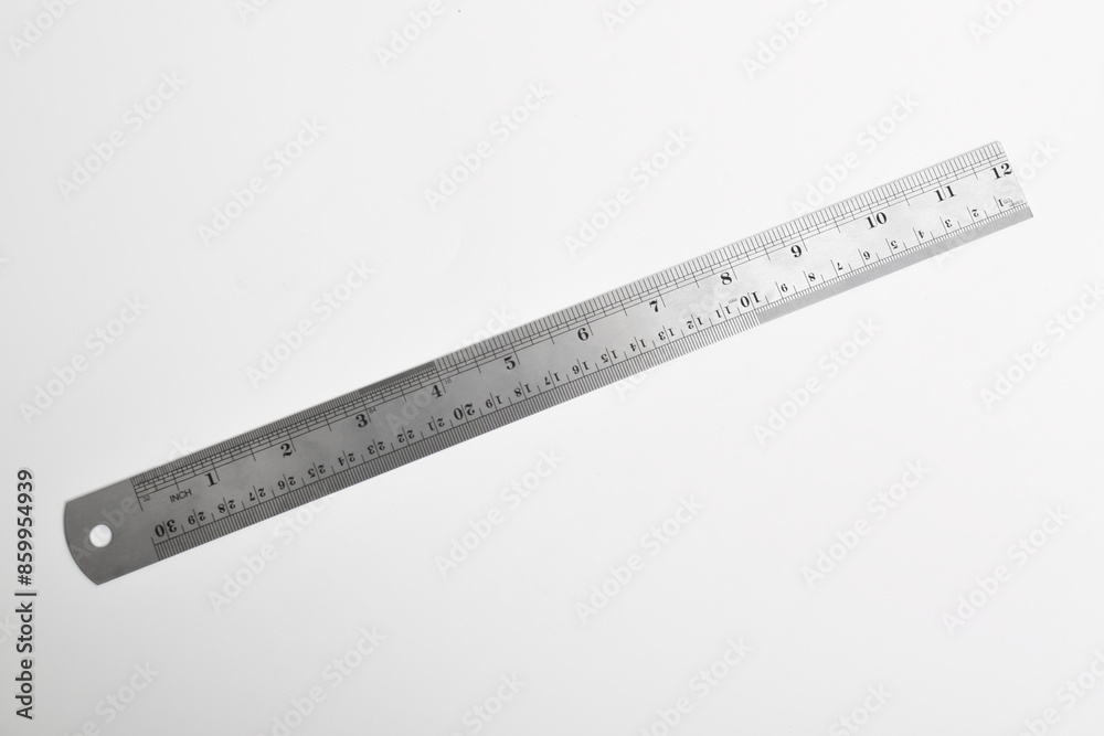Iron ruler on a white background. Stainless steel ruler. Stationery and work tools made of metal steel, isolated on white background Iron ruler on a white background. Stainless steel ruler. Stationery and work tools made of metal steel, isolated on white background