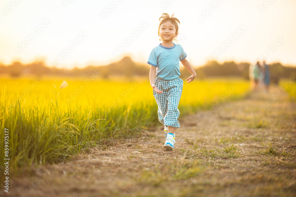 baby girl with happy time on freedom in emotional in outdoor by run play on grasses floor in rice fields blue dress baby girl with happy time on freedom in emotional in outdoor by run play on grasses floor in rice fields blue dress