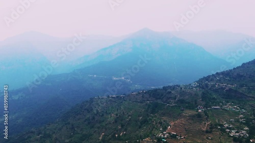 Sagar Village is Chamoli district of Uttarakhand Base of Rudranath Trek aerial view of foggy mountains valley and sky landscape drone shot photo