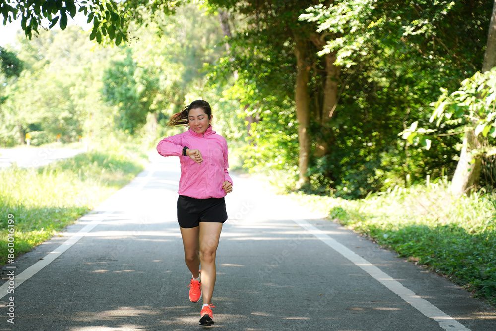 Healthy woman jogging run and workout on road outdoor. Asian runner people exercise gym with fitness session, nature park background. Health and Lifestyle Concept Healthy woman jogging run and workout on road outdoor. Asian runner people exercise gym with fitness session, nature park background. Health and Lifestyle Concept