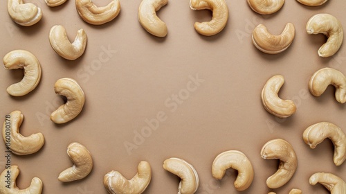 Cashew nuts displayed on light brown surface from above room for text