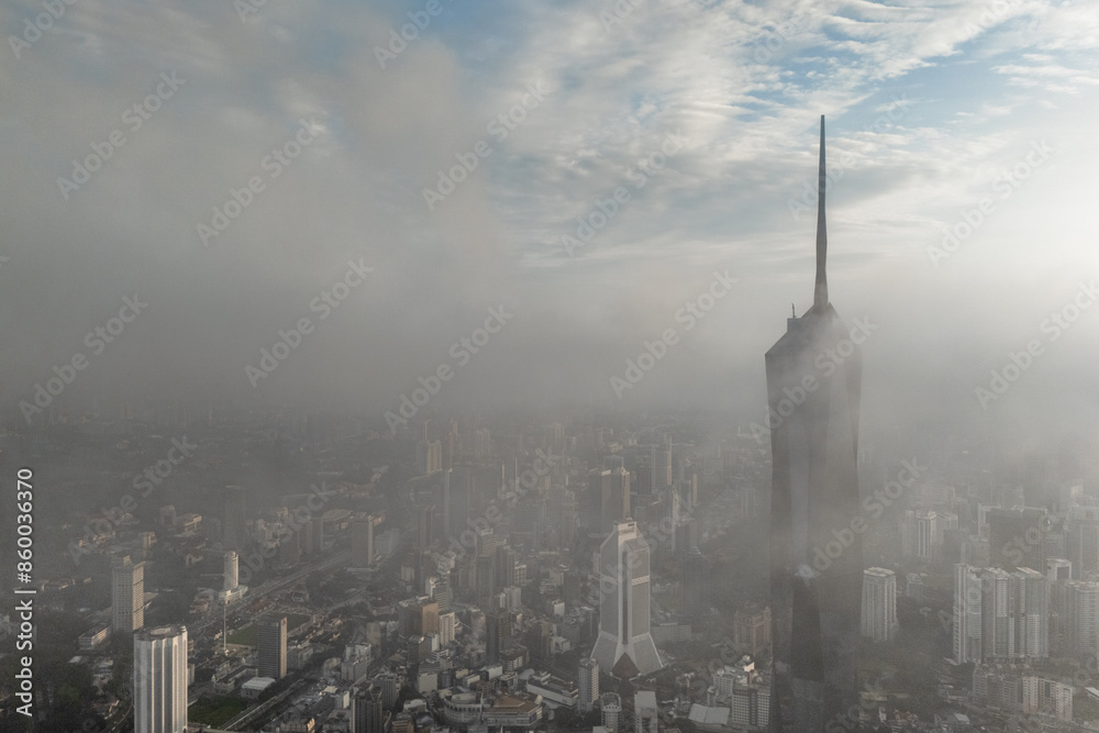 Obraz premium Aerial view PNB118 Tower in Kuala Lumpur City during Low Clouds Monsoon