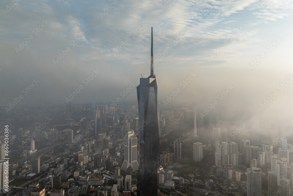 Fototapeta premium Aerial view PNB118 Tower in Kuala Lumpur City during Low Clouds Monsoon