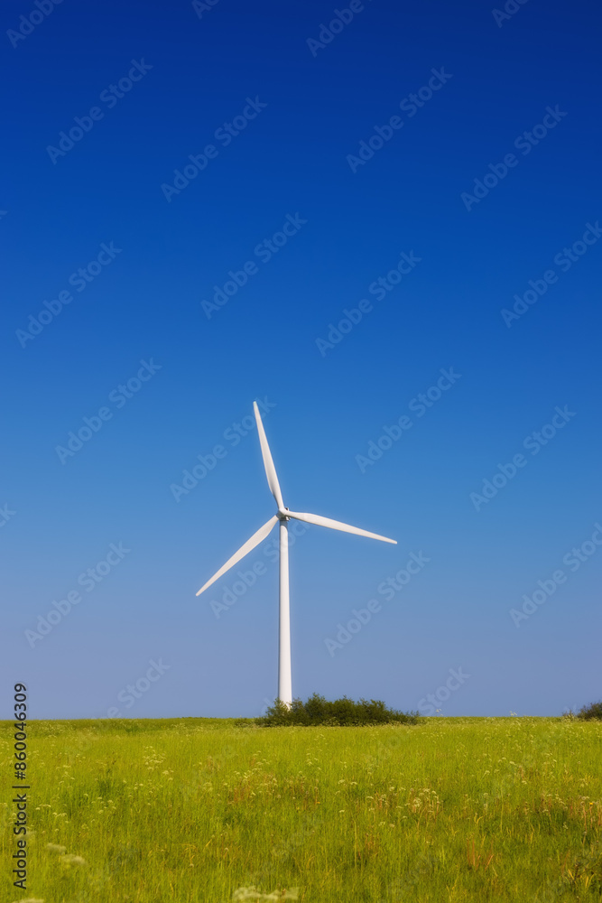 Field, nature and windmill with isolated, blue sky and green energy with economic generator. Abstract, natural electricity and grass landscape for alternative power, wallpaper and eco friendly farm Field, nature and windmill with isolated, blue sky and green energy with economic generator. Abstract, natural electricity and grass landscape for alternative power, wallpaper and eco friendly farm