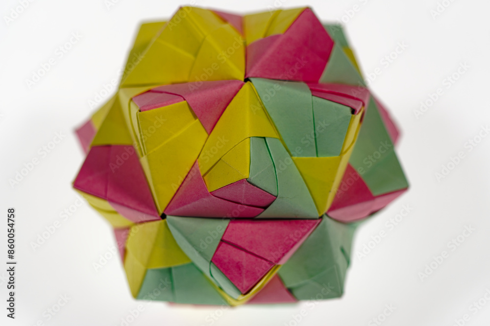 Obraz premium Top view of abstract colorful cube lying on white background. Photo taken June 22nd, 2024, Zurich, Switzerland.