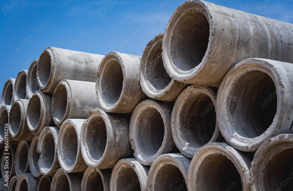 A stack of concrete ring pipes piled and creating a symmetrical arrangement A stack of concrete ring pipes piled and creating a symmetrical arrangement