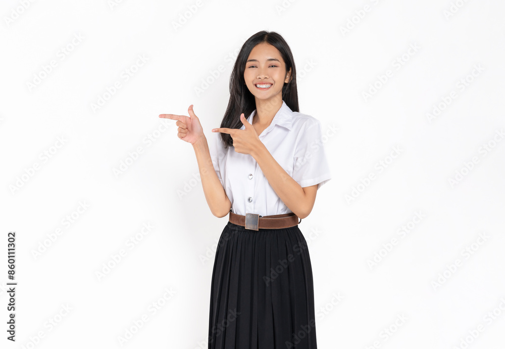 Smiling student girl in university uniform hand pointing upward on white background. Smiling student girl in university uniform hand pointing upward on white background.