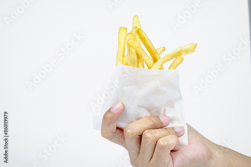 Female hand holding French fries on white background