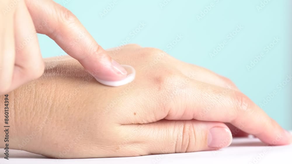 A woman applies moisturizer cream on her hands. Close up A woman applies moisturizer cream on her hands. Close up