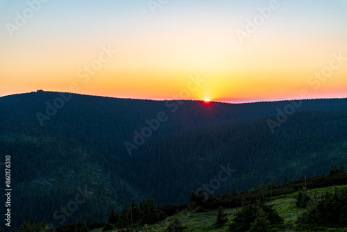 Sunset bellow Vozka hill from Cervena hora hill in Jeseniky mountains in Czech republic photo