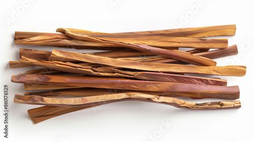 Sandalwood in the form of isolated sticks, seen from above on a white background, draws attention to the natural structure and shape of the wood.