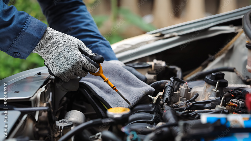 Car care and service A technician is troubleshooting an engine. Spare parts of car engines that have problems and support car insurance services, standard car repair service center concepts. Car care and service A technician is troubleshooting an engine. Spare parts of car engines that have problems and support car insurance services, standard car repair service center concepts.