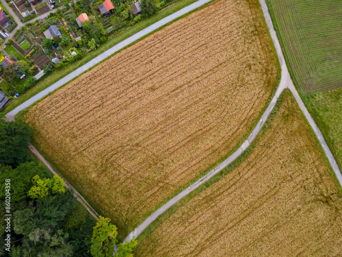 farmland framed by countryroads, colorful gardenhouses and forest, diagonal, urban living concept,  recreational space, aerial view photo