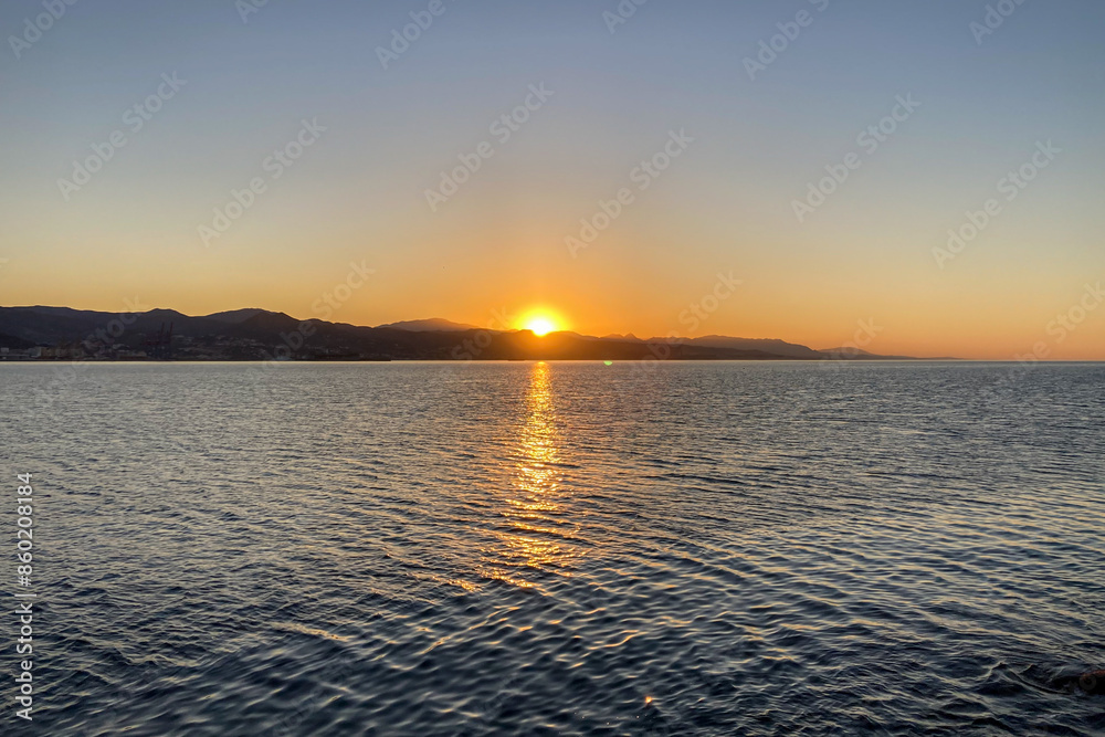 Obraz premium Sunrise over the beach and city in Malaga, Spain