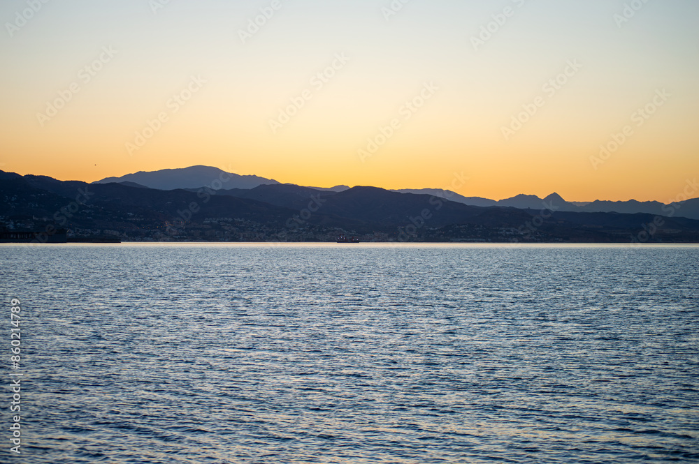Sunrise over the beach and city in Malaga, Spain Sunrise over the beach and city in Malaga, Spain