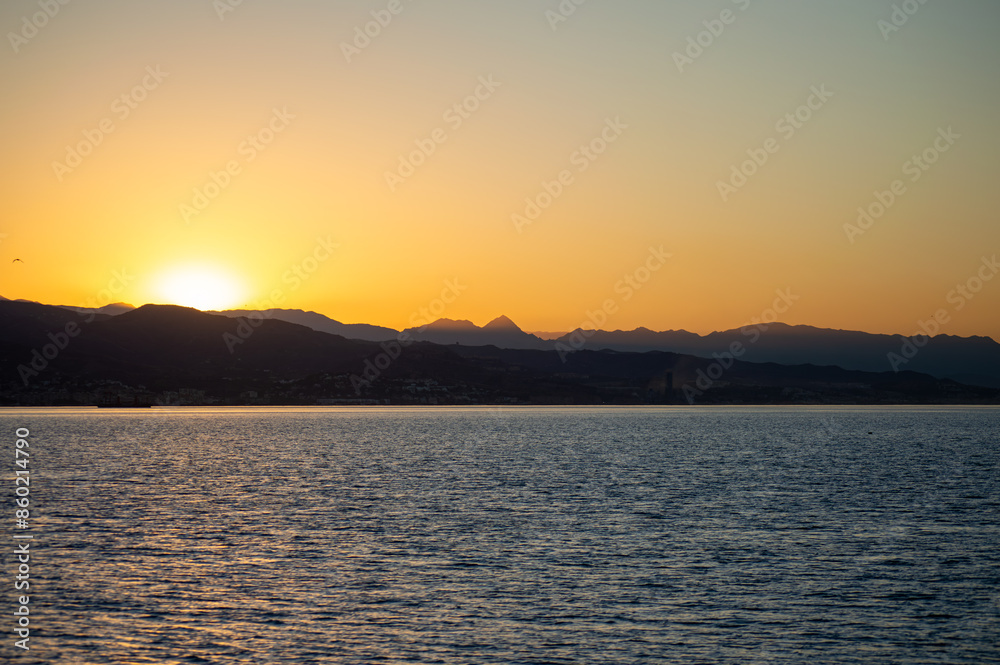 Naklejka premium Sunrise over the beach and city in Malaga, Spain