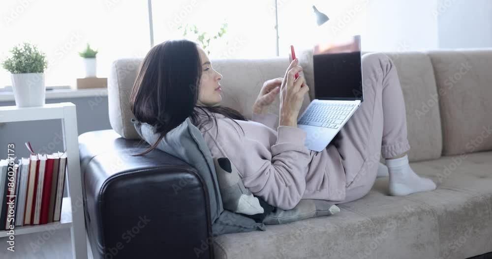 Woman working remotely at home and receiving unpleasant message on her phone 4k movie. Bad news concept Woman working remotely at home and receiving unpleasant message on her phone 4k movie. Bad news concept