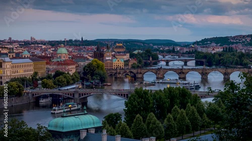 Panned summer sunset to night time lapse of the cityscape of Prague, Czech Republic, with the various bridges over Vltava River and the old town