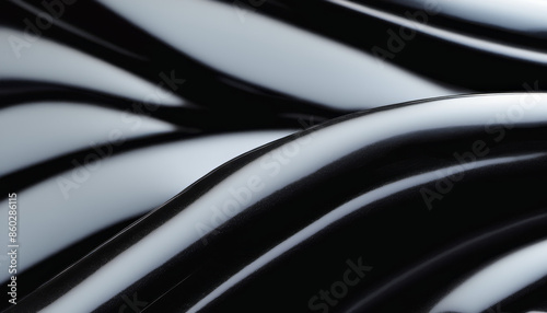 The image is a black and white photo of a wave. The wave is very long and has a very smooth texture. The photo has a very artistic and abstract feel to it