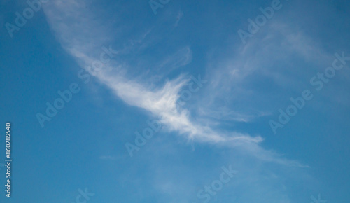 A small cloud high in the sky. Blue sky and clouds