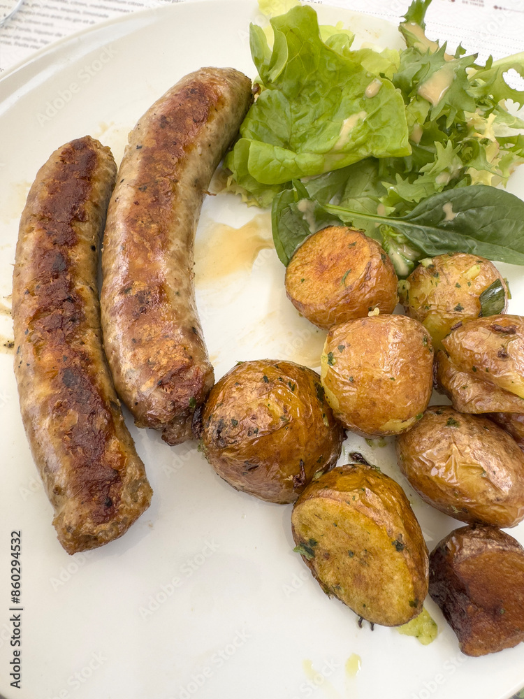 grilled sausages with potatoes and salad on plate grilled sausages with potatoes and salad on plate
