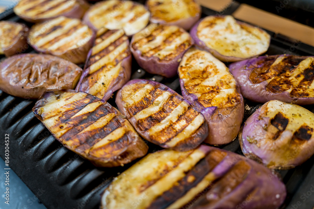 Delicious grilled eggplants with garlic on the electric grill Delicious grilled eggplants with garlic on the electric grill