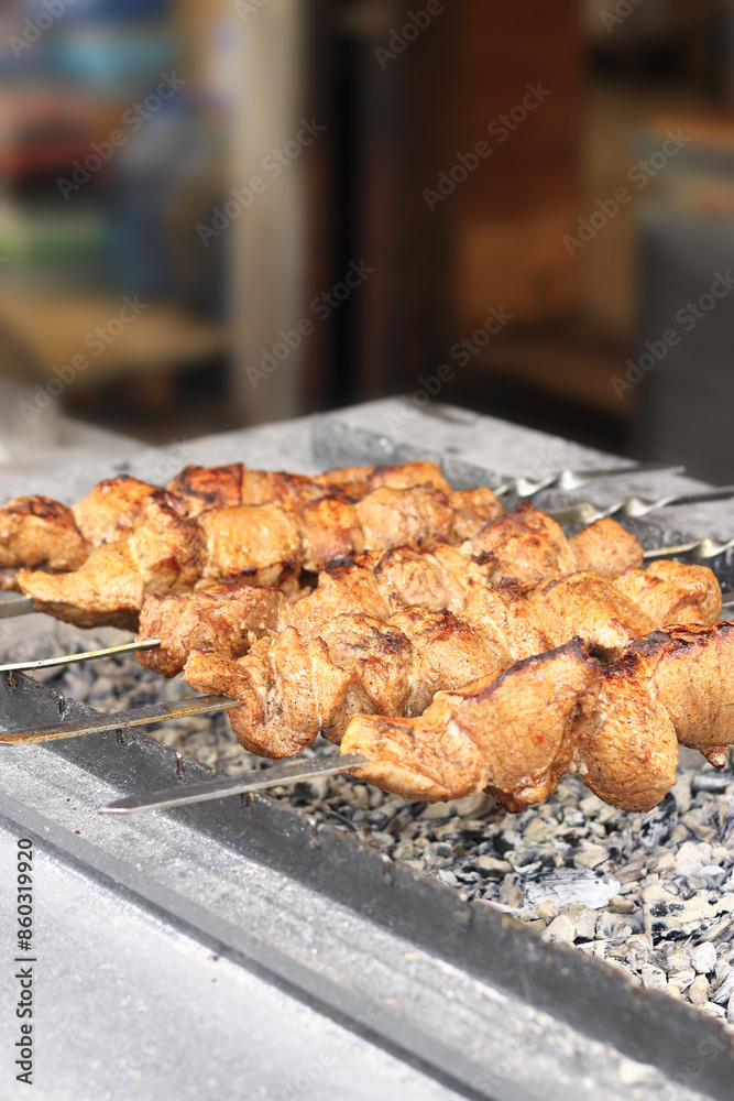 Kebabs on skewers, close-up. Food court at the fair, outdoor cooking. Hot and tasty food. Cooking shish kebab on coals. Grilled kebab cooked on a metal skewer Kebabs on skewers, close-up. Food court at the fair, outdoor cooking. Hot and tasty food. Cooking shish kebab on coals. Grilled kebab cooked on a metal skewer