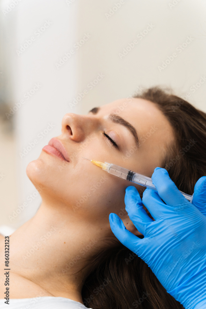 Attractive girl improves skin condition in cosmetology clinic. Cosmetology injections for getting rid of wrinkles. Attractive girl improves skin condition in cosmetology clinic. Cosmetology injections for getting rid of wrinkles.