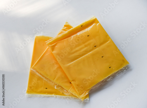 Melted cheese in flat slices. Processed cream cheese for sandwiches. photo