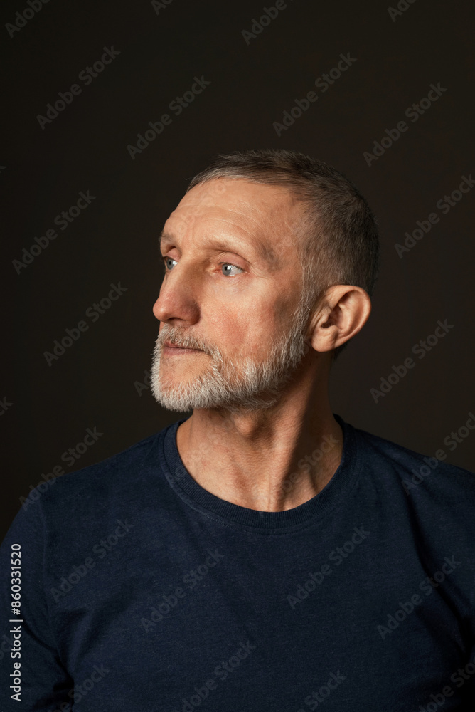 portrait of a handsome elderly man with a beard on a black background, close-up, selective focus
